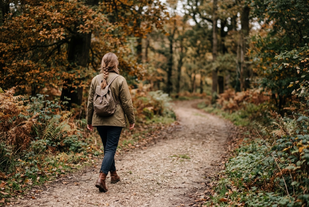 Person walking outdoors on a quiet path, natural daylight